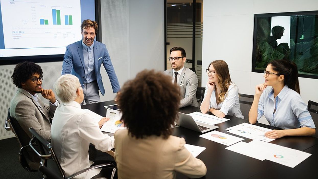 Man presents updates to executives/C-suite members