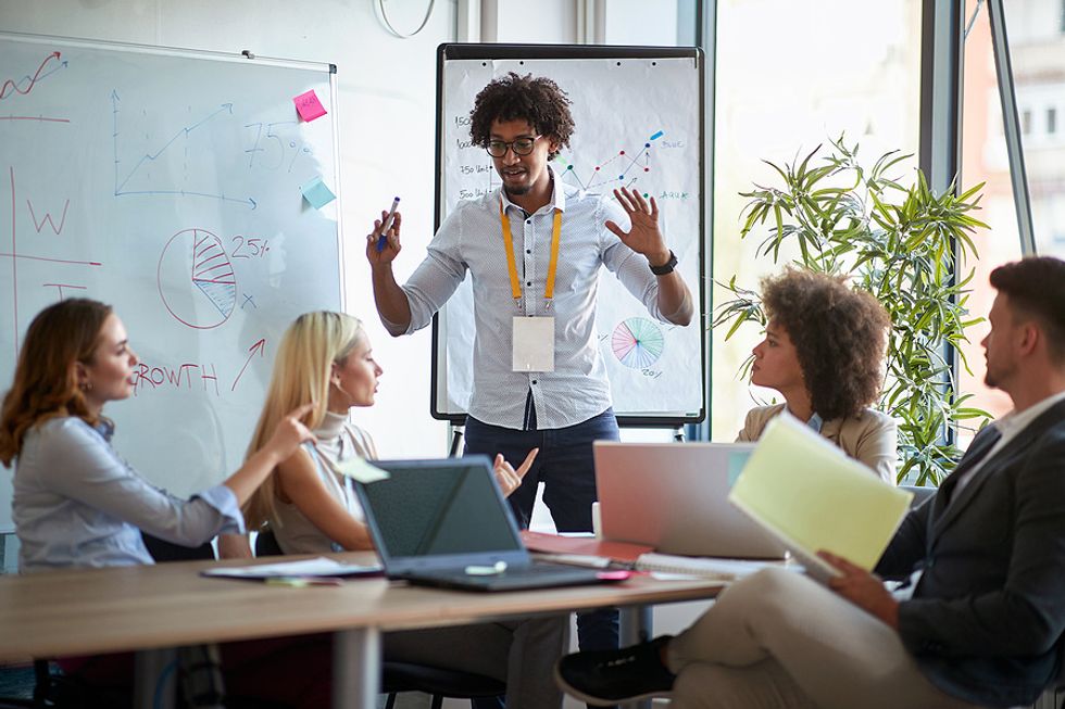 Man promotes his personal brand at work during a meeting