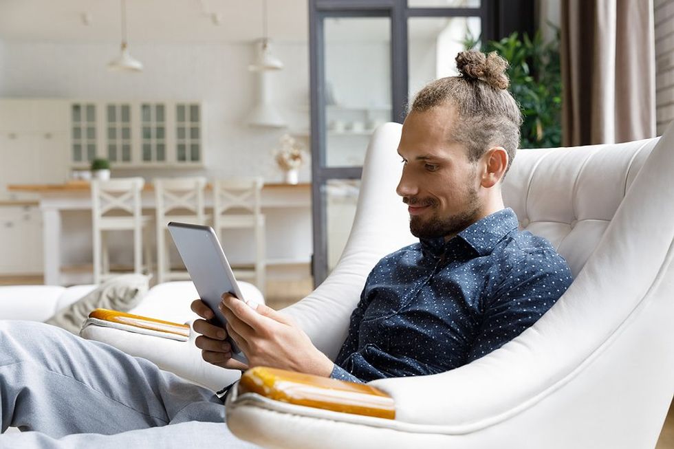 Man reads a book on his tablet