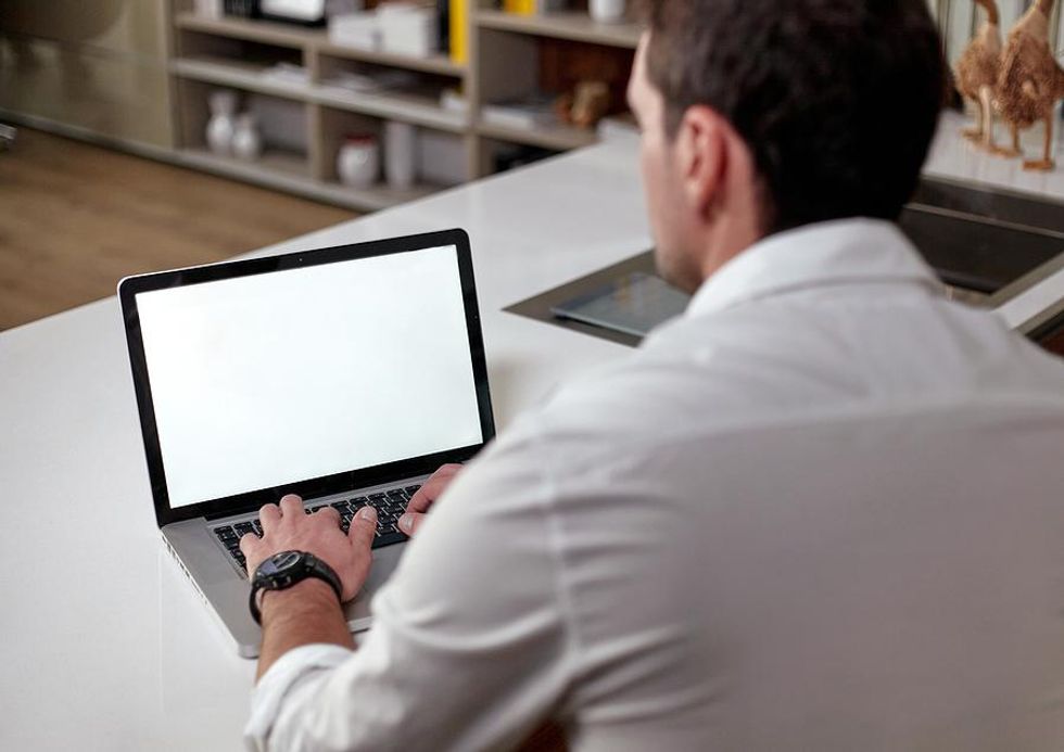 Man reads about the companies that announced employee layoffs