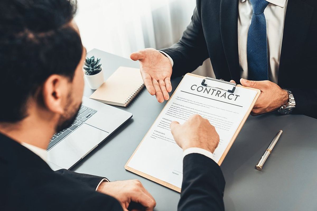 Man reads his employment contract after negotiating his salary in the job interview