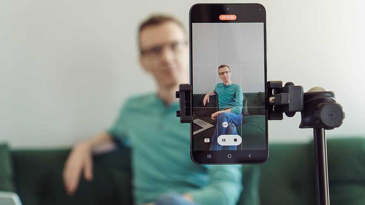 Man recording a video on his phone to post on LinkedIn to boost his career visibility