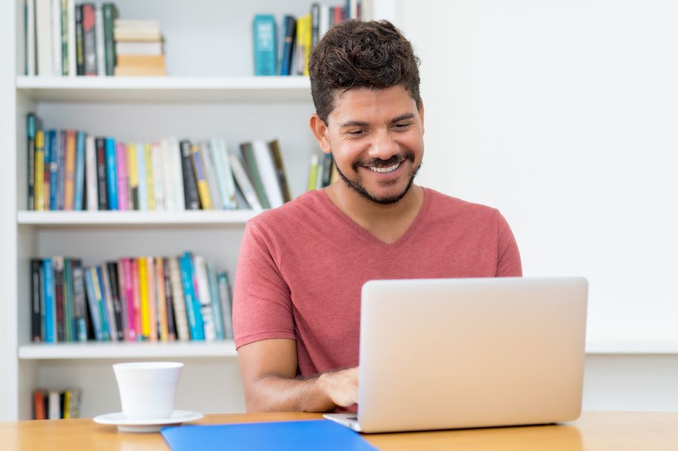 Man researches a company on his laptop before his job interview