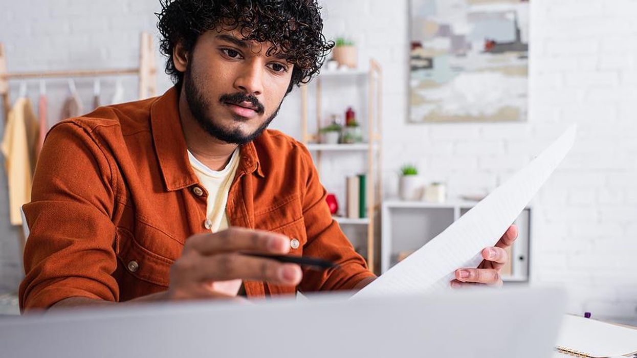 Man reviews his resume before applying for a job