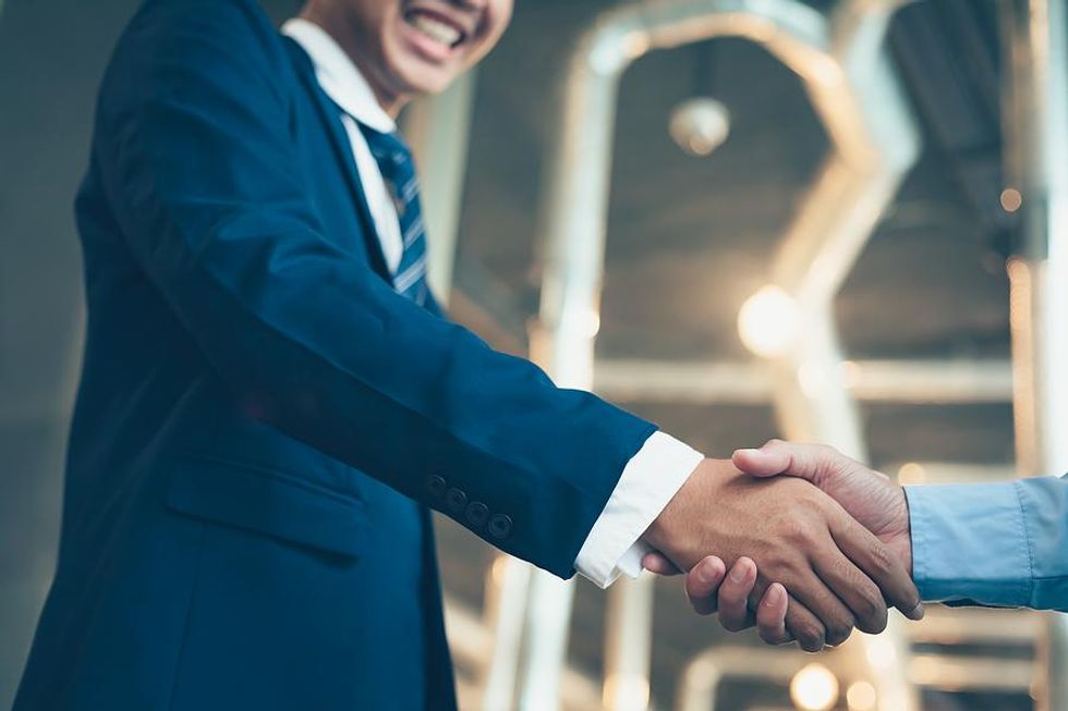 Man shakes hands at a networking event