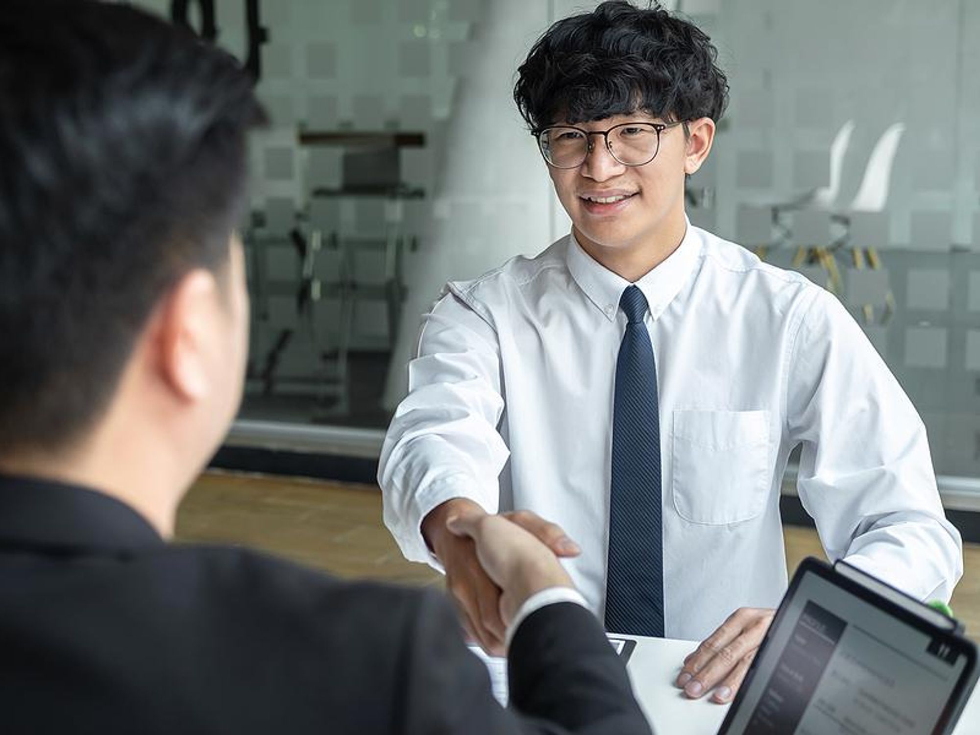 Man shakes hands before an interview