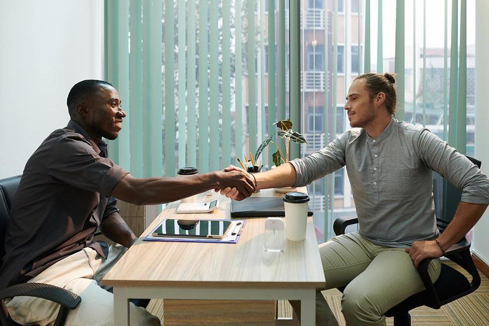 Man shakes hands with the hiring manager after a job interview