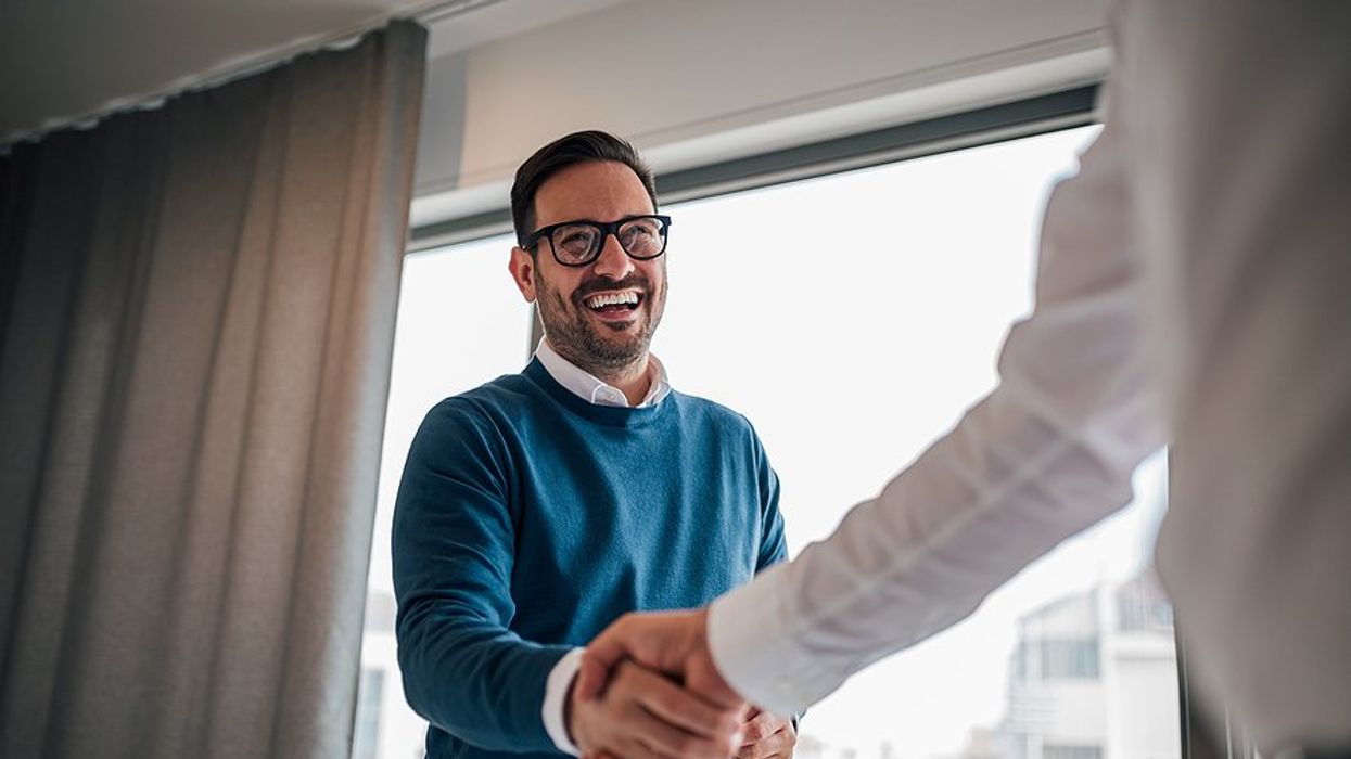 Man shakes hands with the hiring manager after accepting a job offer