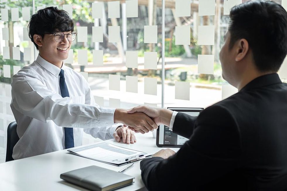 Man shakes hands with the hiring manager before a job interview