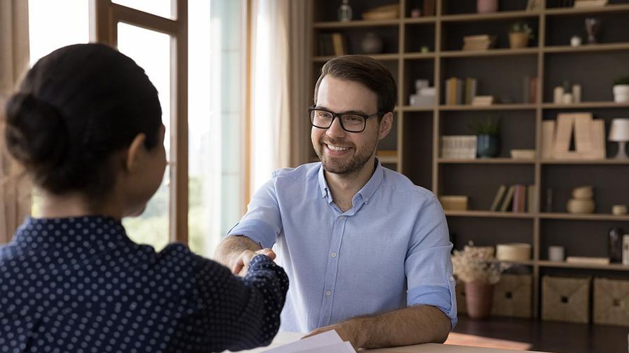 Man shakes hands with the hiring manager before a job interview