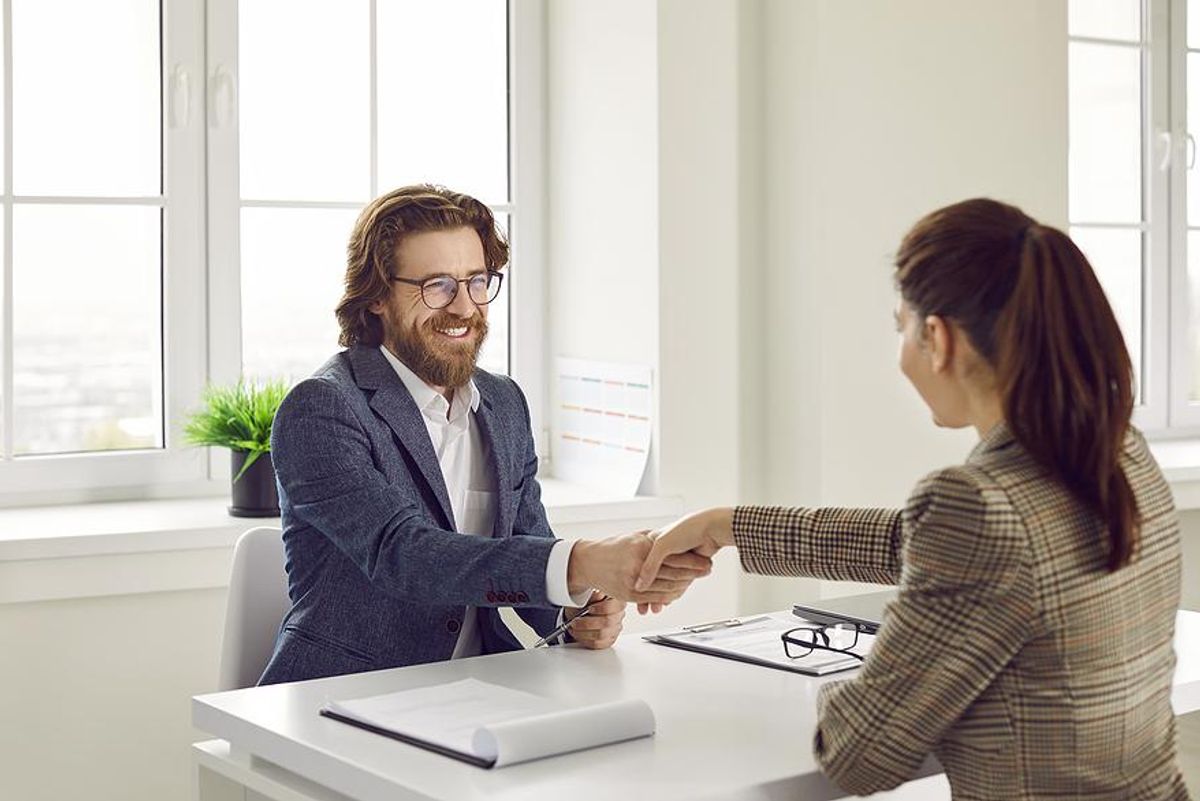 Man shakes his friend's hand before his mock interview