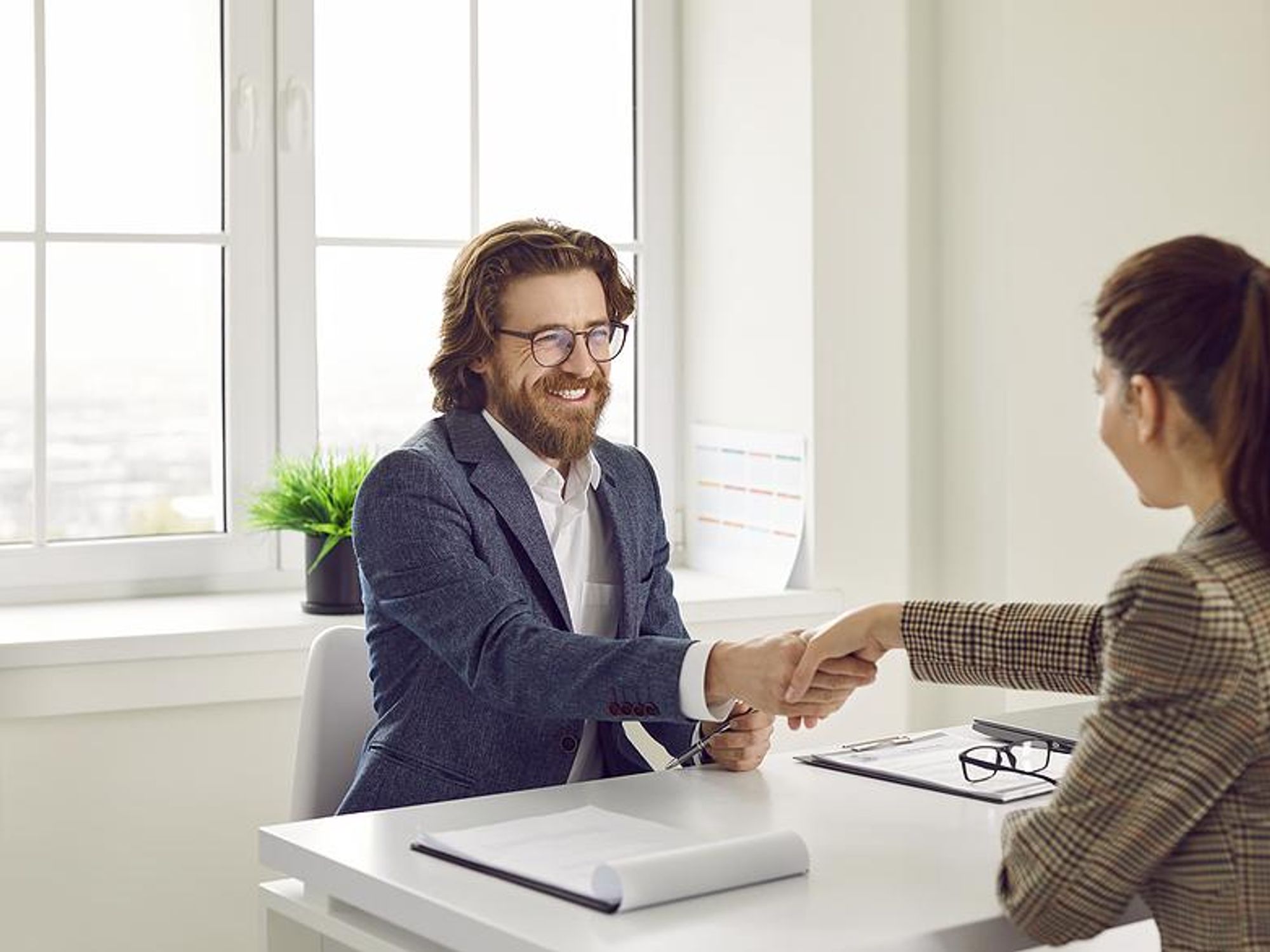 Man shakes his friend's hand before his mock interview