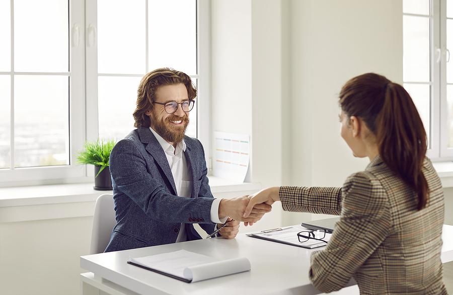 Man shakes his friend's hand before his mock interview