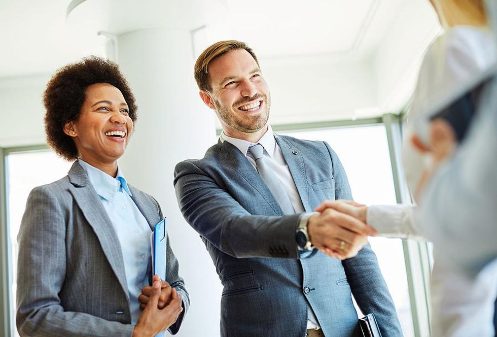 Man shakes someone's hand while networking