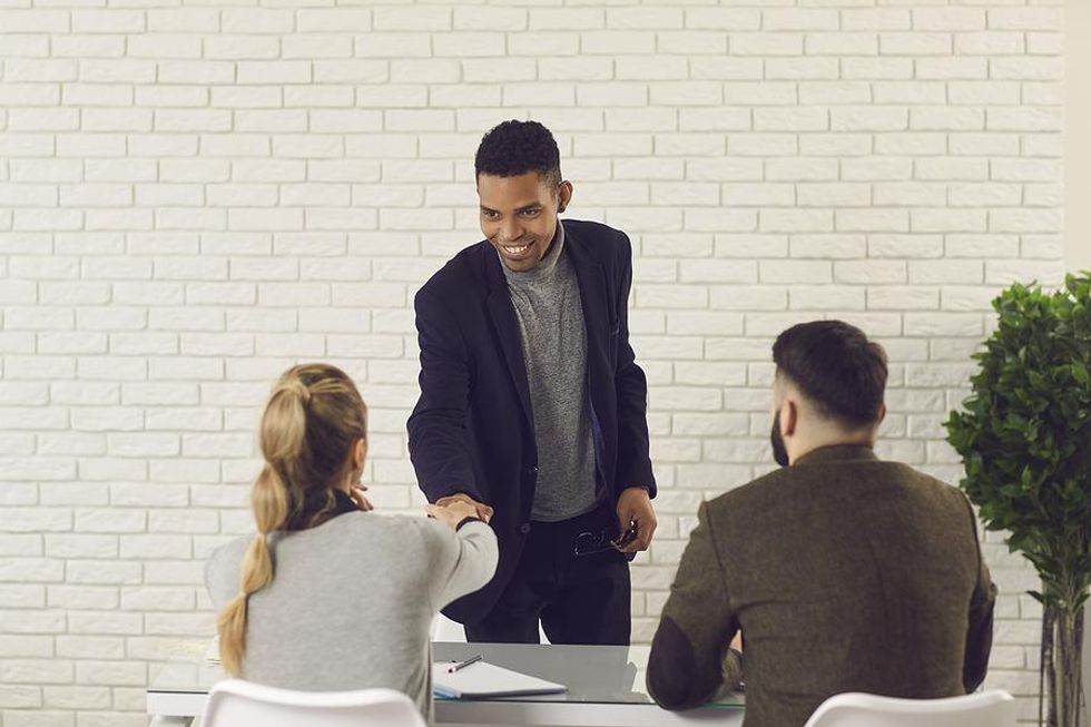 Man shakes the hand of the hiring manager before his job interview