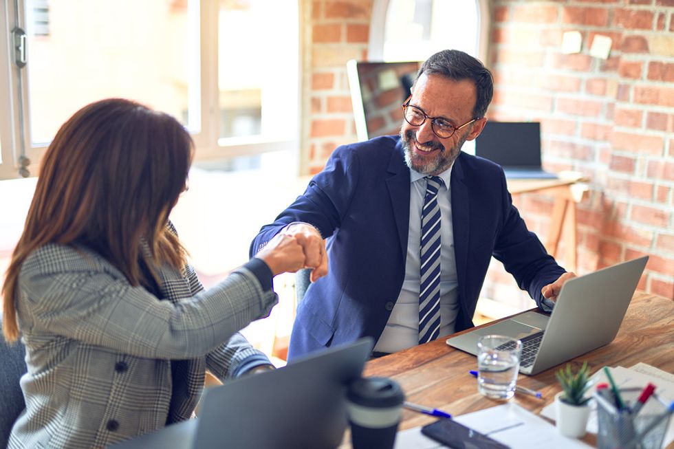 Man smiles at his new job after making a career change