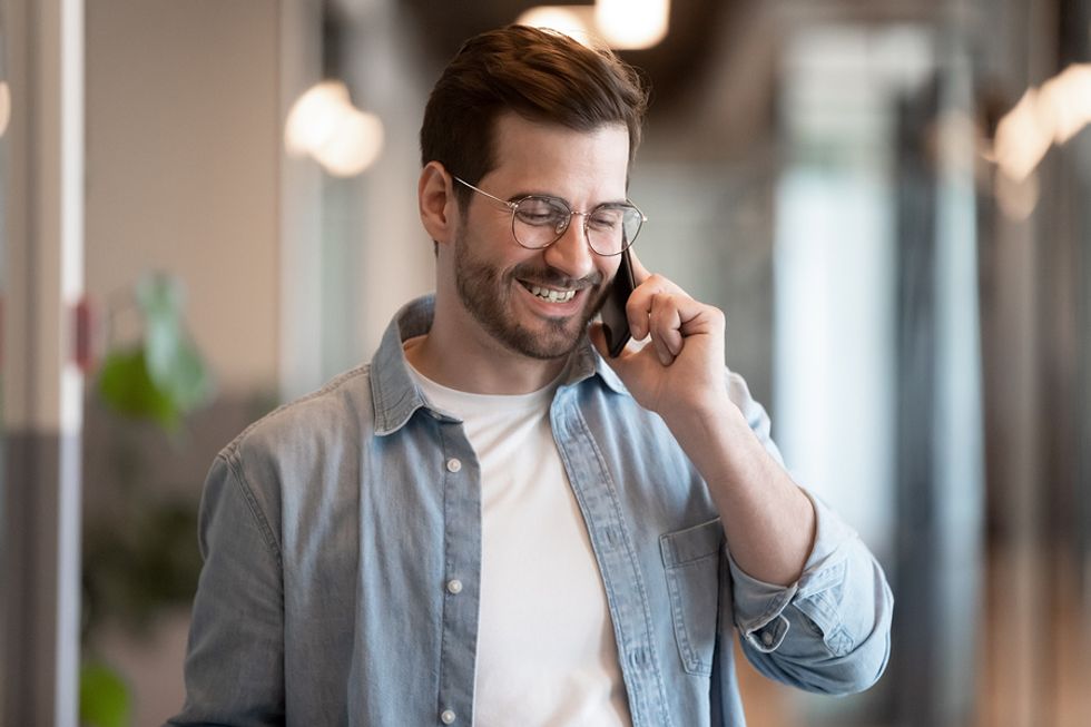 Man smiles during his phone interview