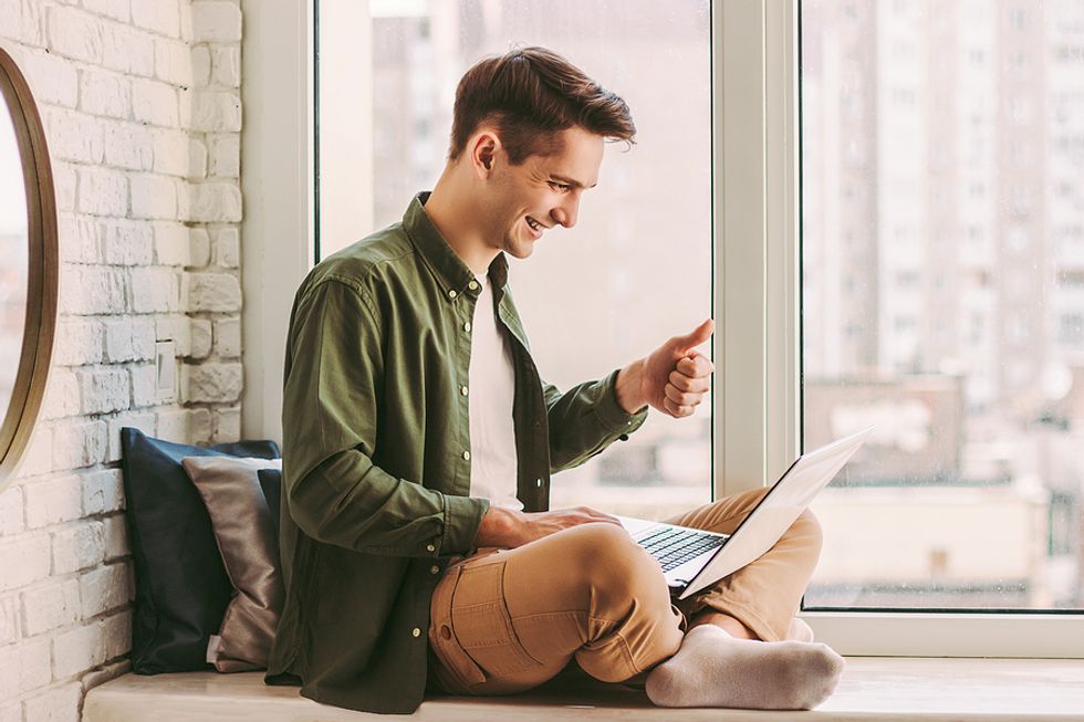 Man smiles while attending a virtual networking event