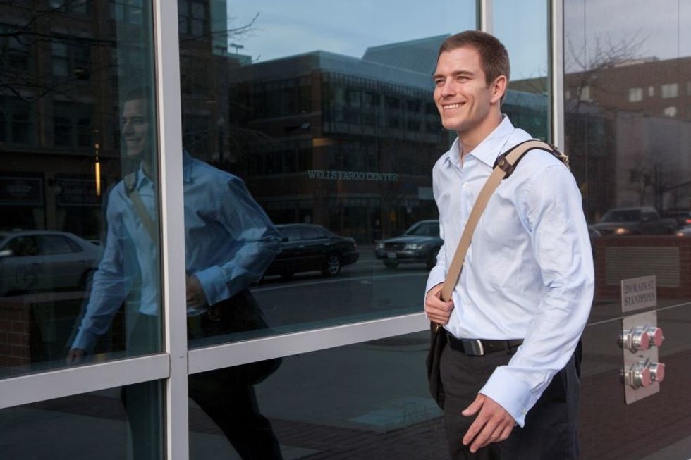 Man smiles while walking to work