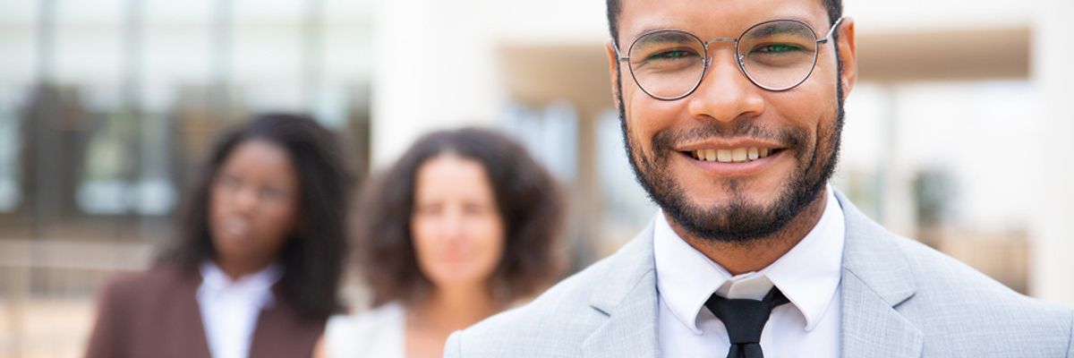 Man smiling after tailoring his resume for a leadership role and landing a leadership position.