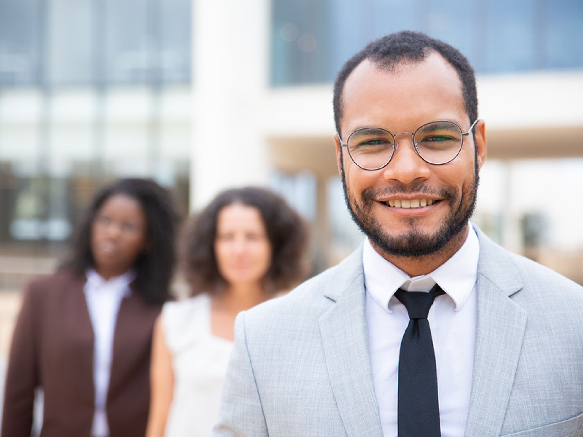 Man smiling after tailoring his resume for a leadership role and landing a leadership position