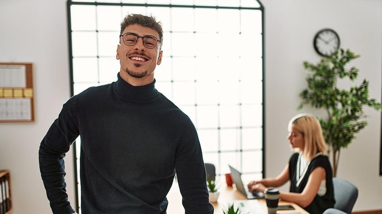 Man standing up at work to stay healthy