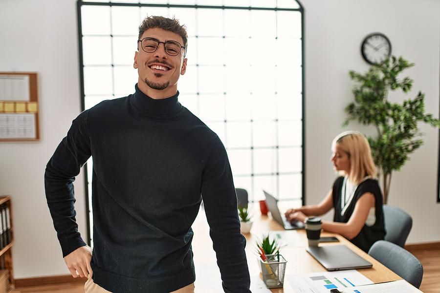 Man standing up at work to stay healthy