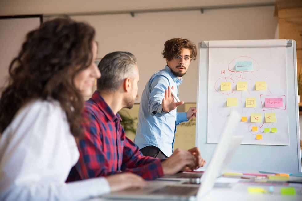 Man stands out during a meeting at work