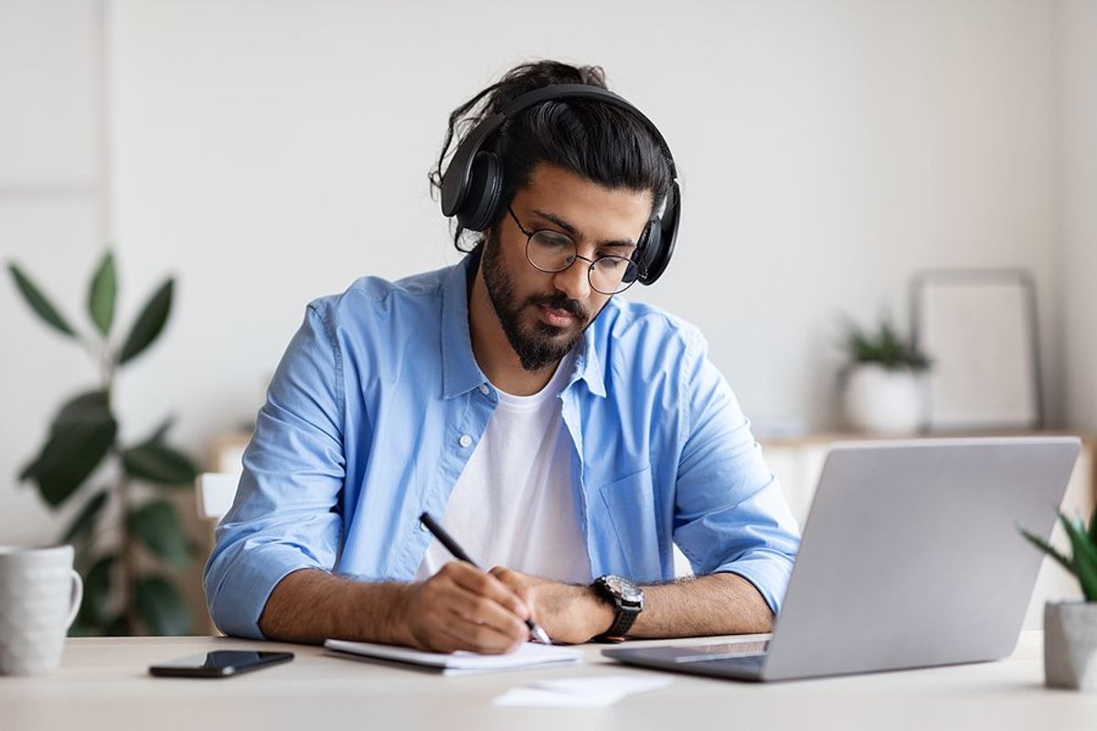 Man takes an online course on his laptop to upskill in his career