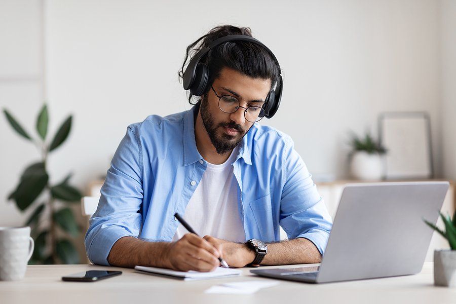 Man takes an online course on his laptop to upskill in his career