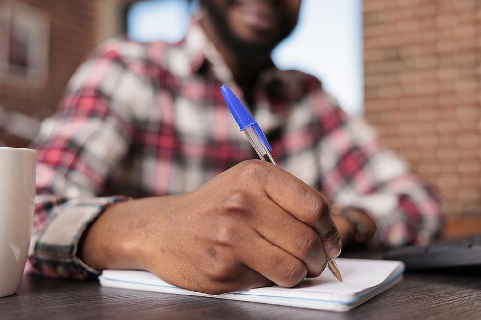 Man takes notes at work