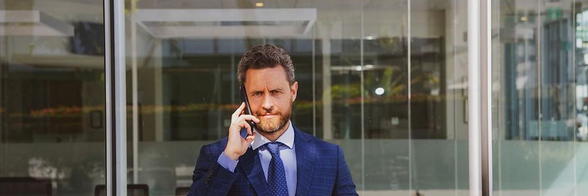 Man talking on phone at work