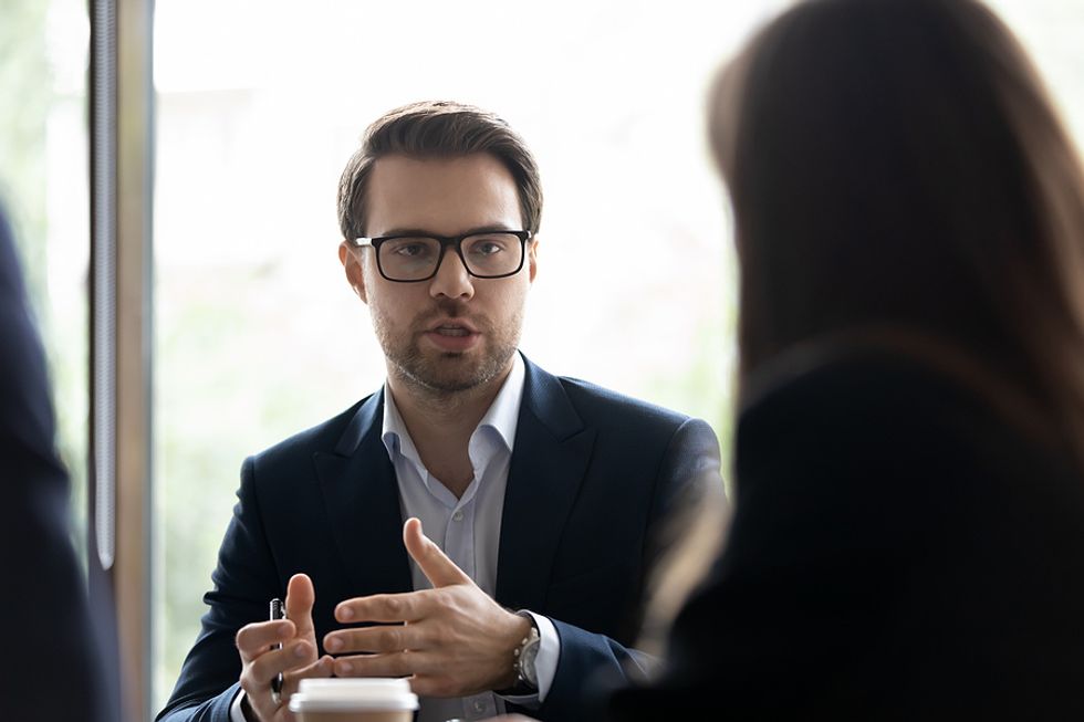 Man talks about his intangible skills during a job interview / work meeting