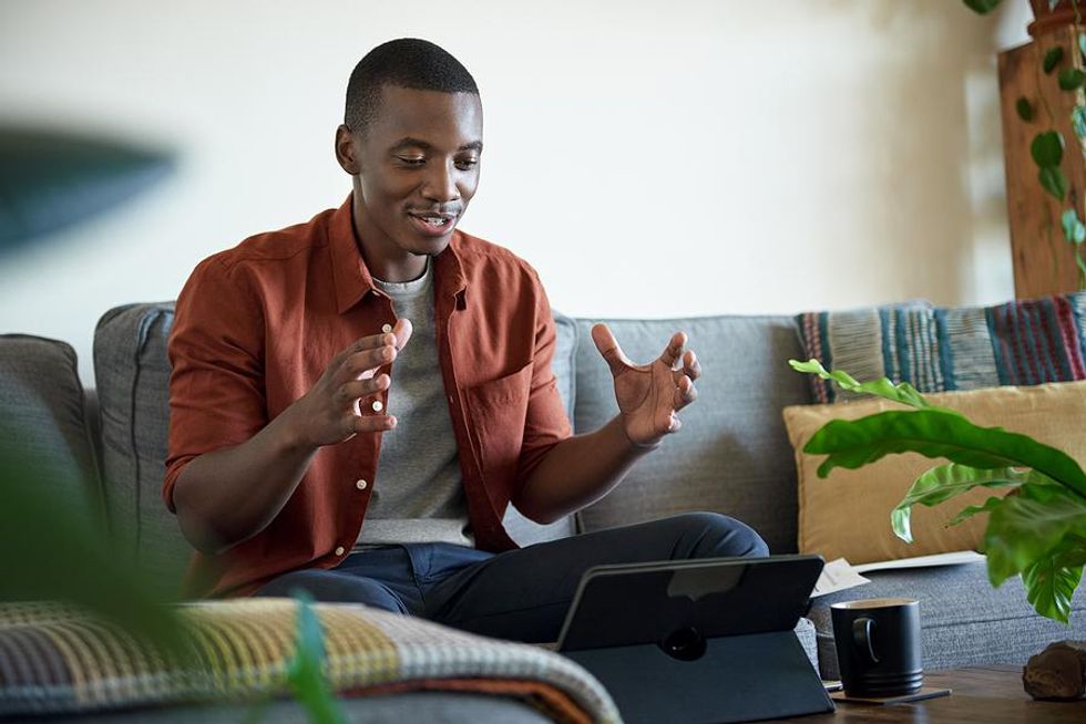 Man talks during a meeting for his work-from-anywhere job