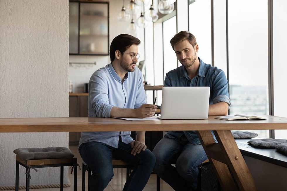 Man talks to a coworker in the office