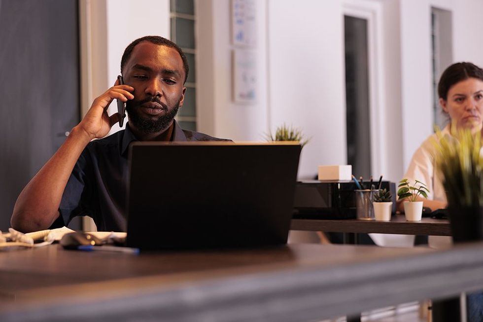 Man talks to difficult customers/clients on the phone