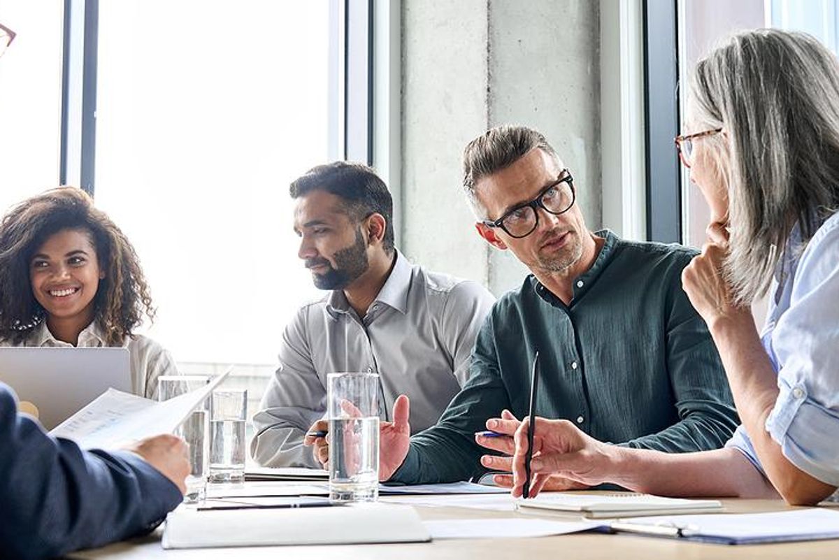 Man talks to his boss during a work meeting