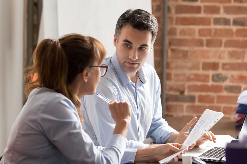 Man talks to his manager about her expectations so he can become an indispensable employee