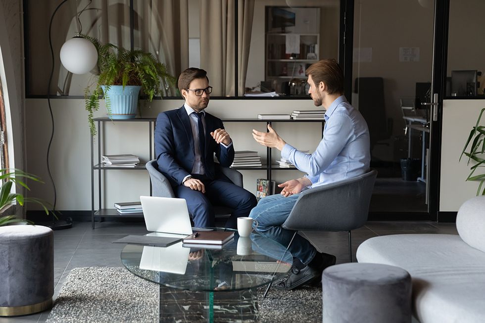 Man thanks his boss after quitting his job during a meeting