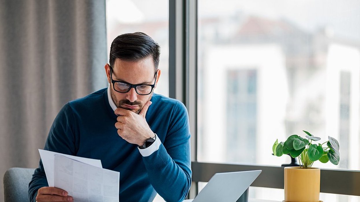 Man thinks while holding his executive resume