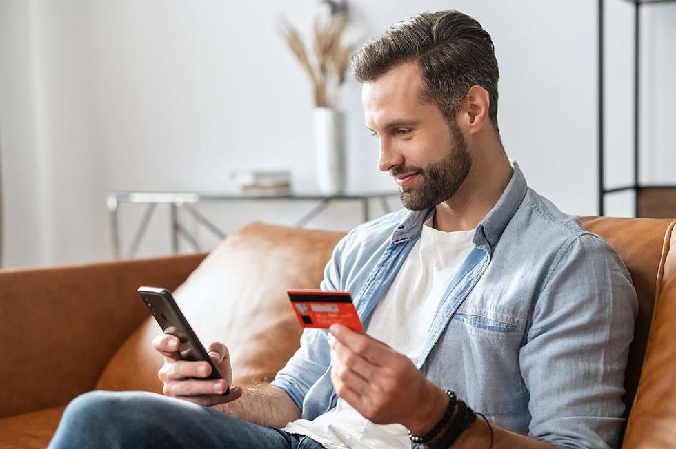 Man types his credit card number into his phone