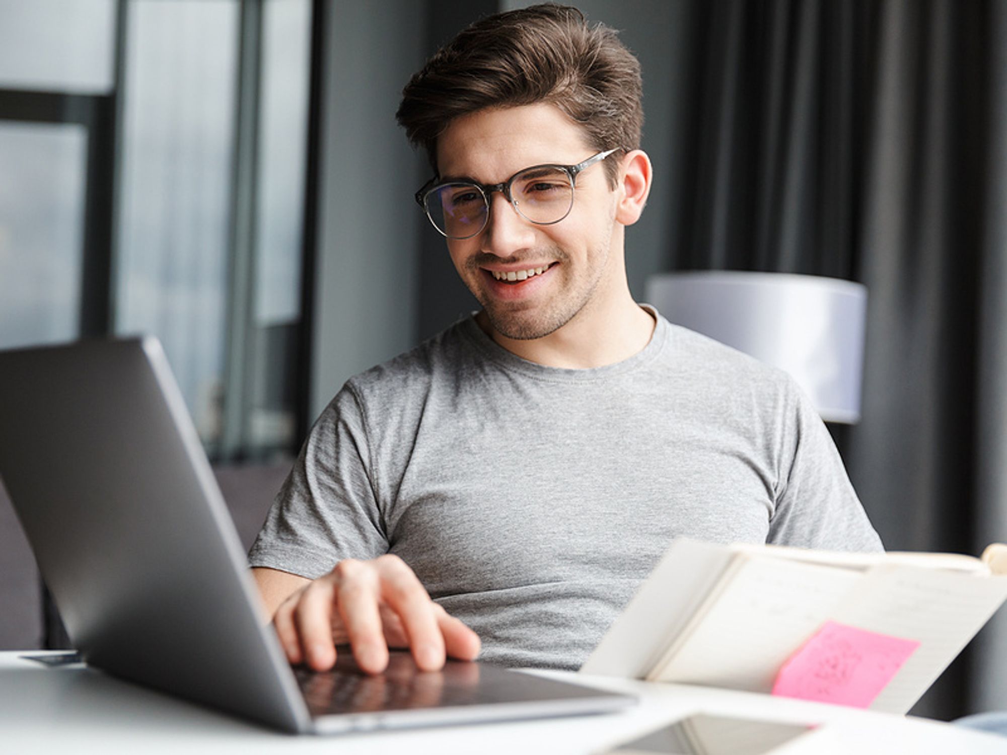 Man using a laptop quantifies information on his resume
