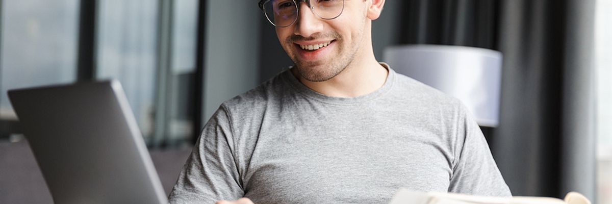 Man using a laptop quantifies information on his resume