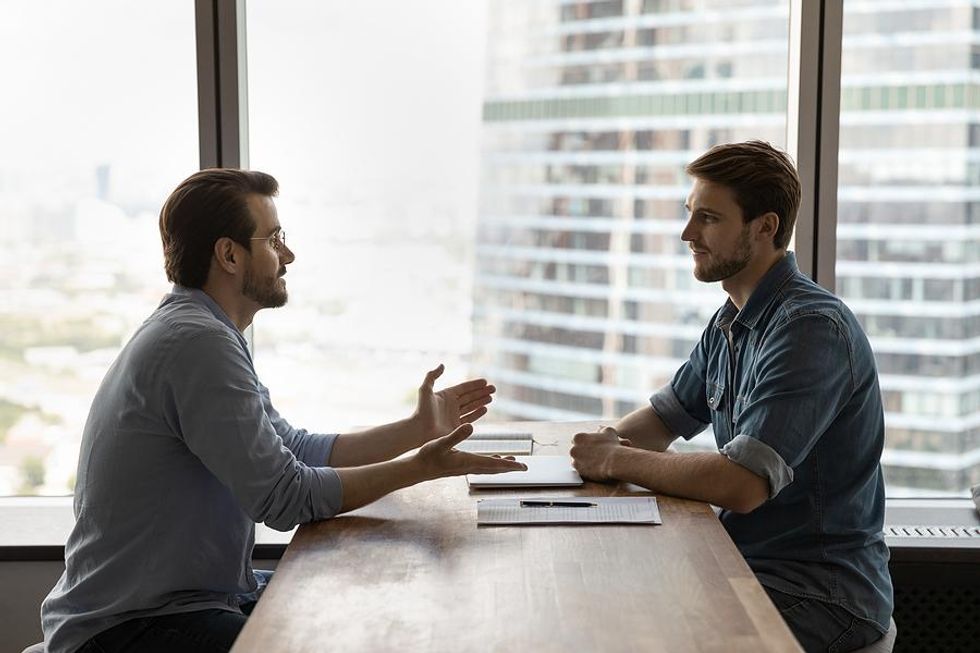 Man with good body language answers a question during a job interview