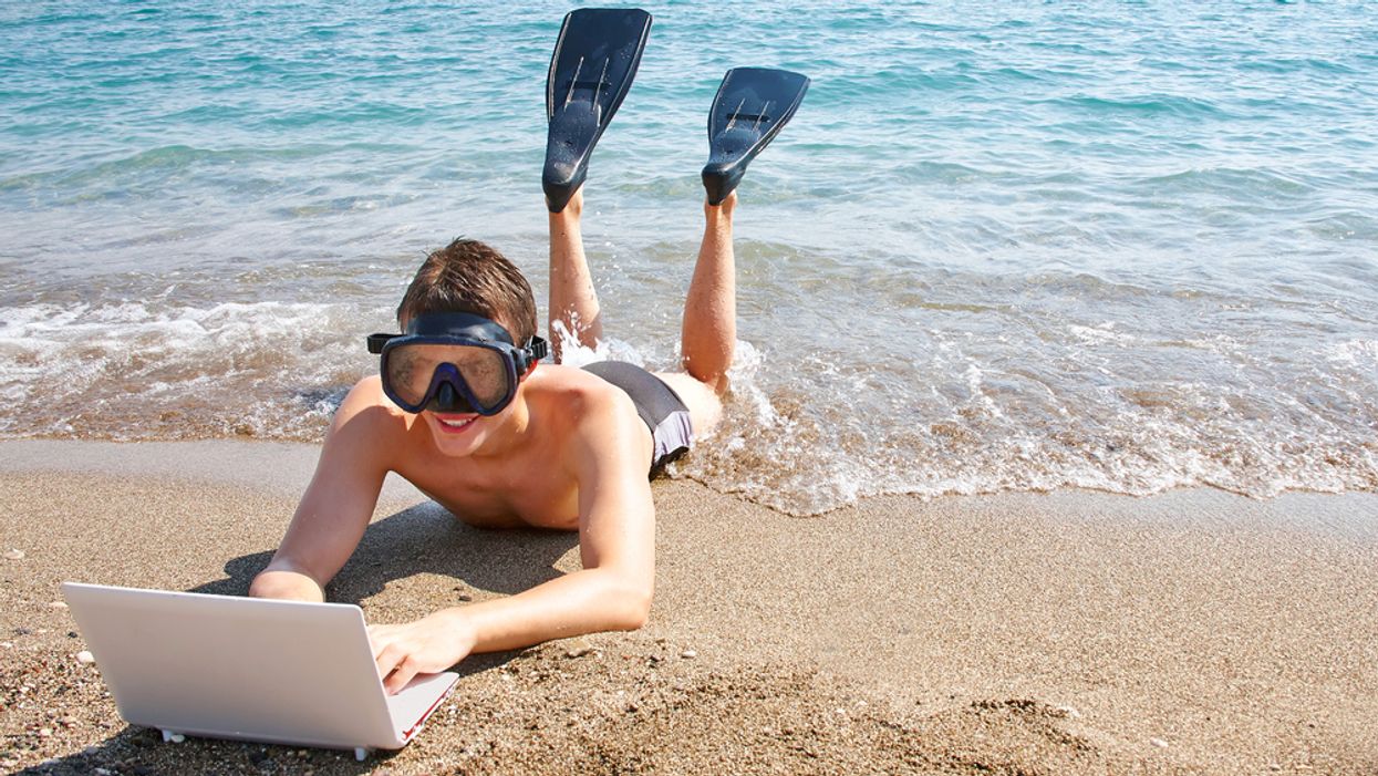 Man works on his career at the beach