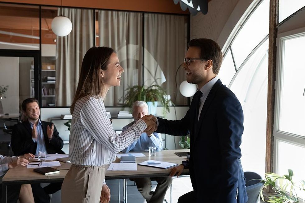 Manager congratulates his colleague