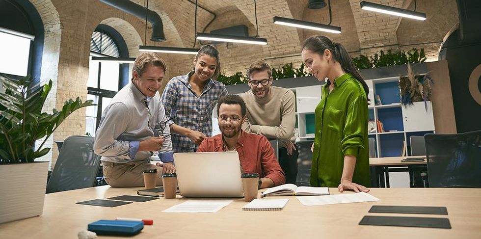 Manager hangs out with coworkers in the office