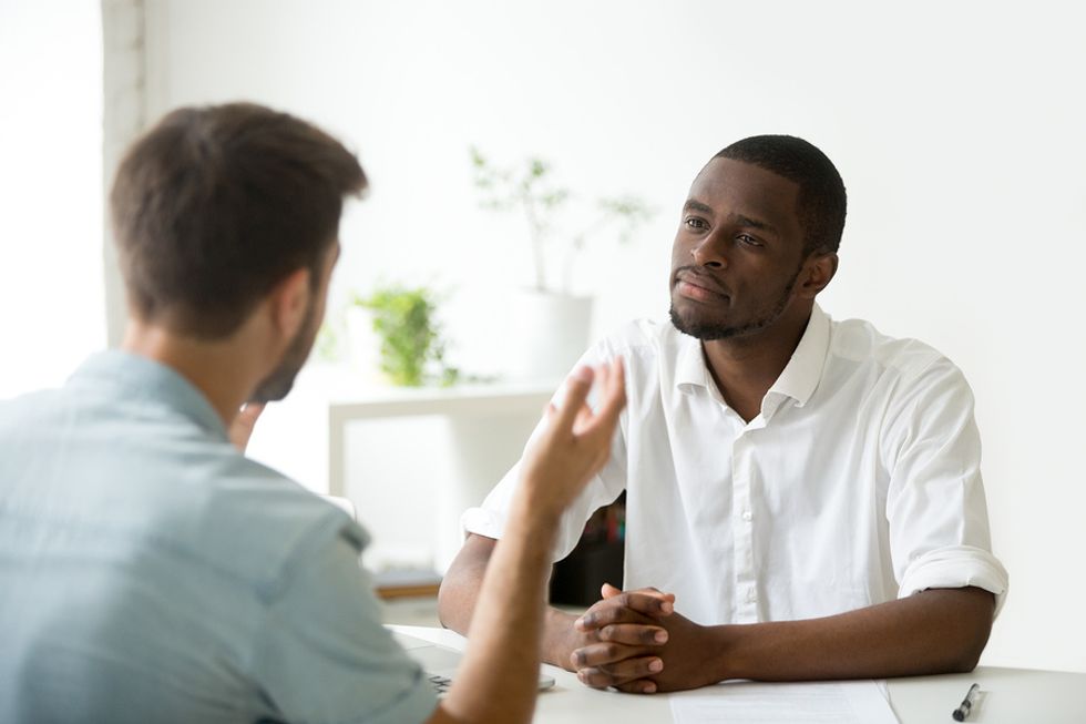 Manager listens to an underperforming employee during a meeting