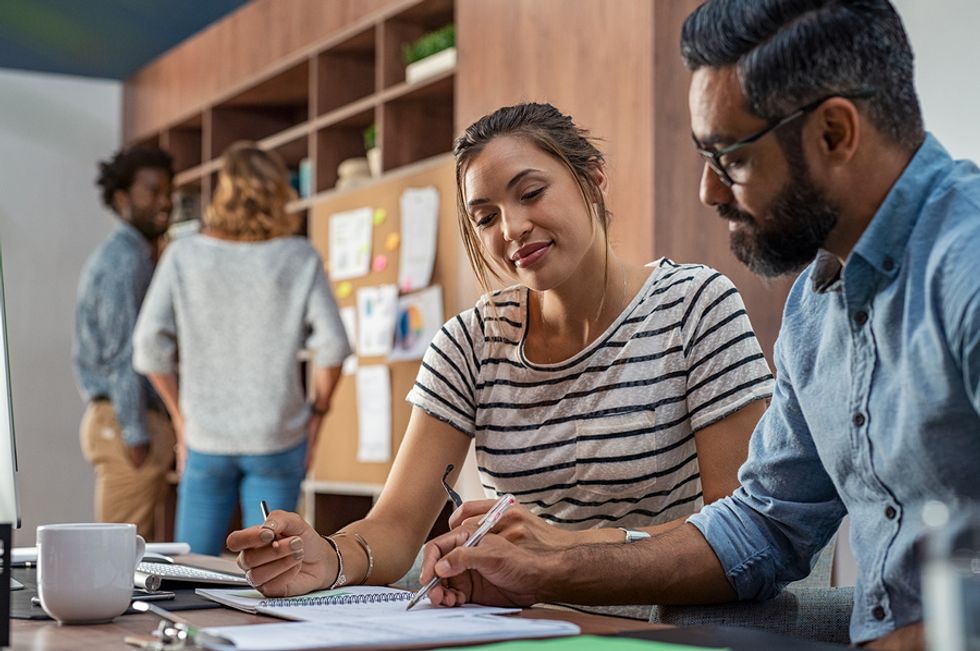 Manager uses his leadership skills to help a younger team member at work