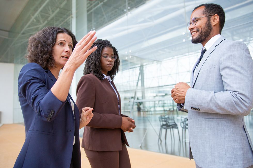 Manager using her soft skill of clear communication to lead two members of her team